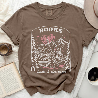 Brown t-shirt with "BOOKS, a heart, hockey sticks, and slow burns" graphic.