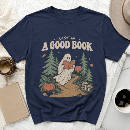 Ghost reading a book in a forest with text "LOST IN A GOOD BOOK".