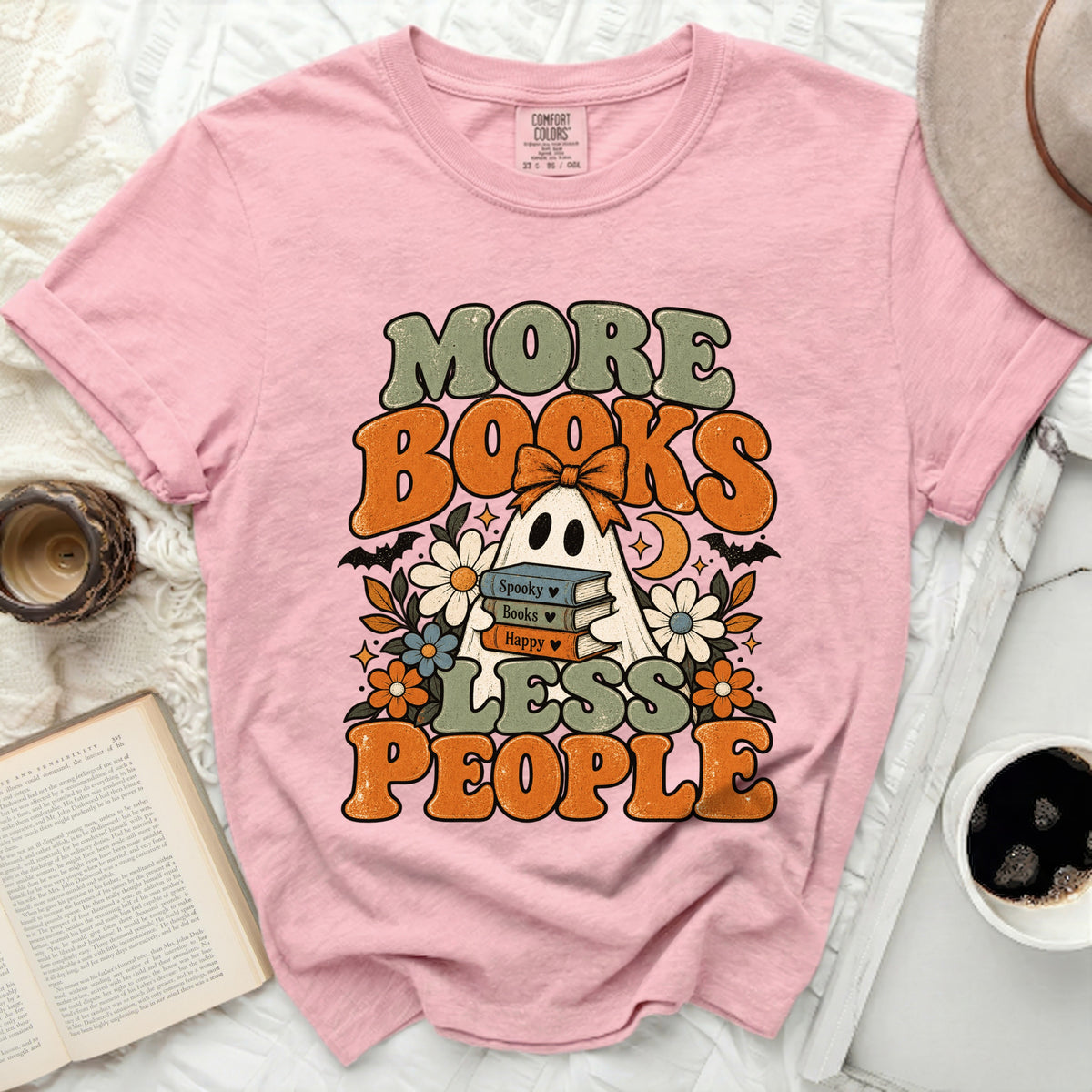 Pink t-shirt with "More Books Less People" graphic featuring a ghost and books.