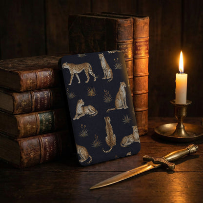Dark blue case with cheetah pattern, antique books, and candle.