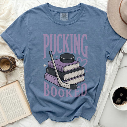 Blue t-shirt with "PUCKING BOOKED" and hockey puck on stacked books.