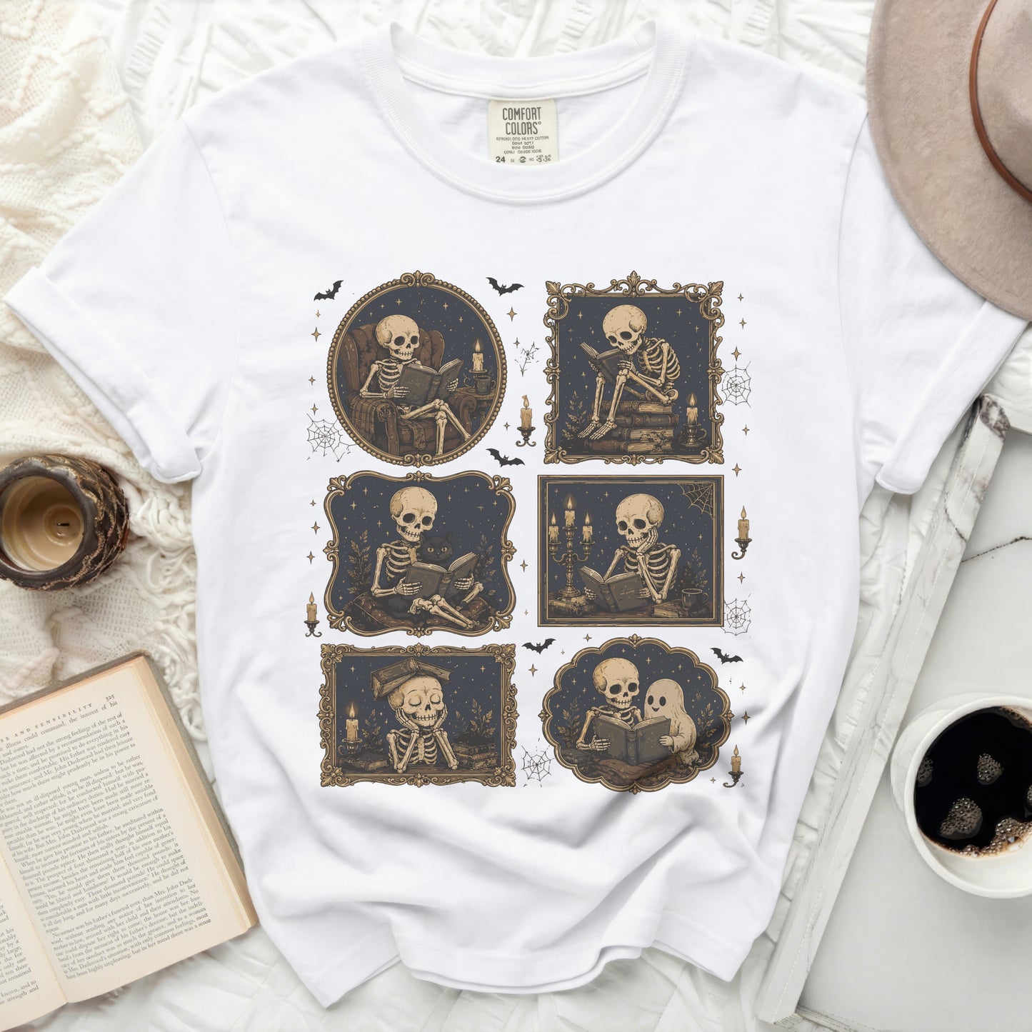 White t-shirt with six framed illustrations of skeletons reading and a hat.