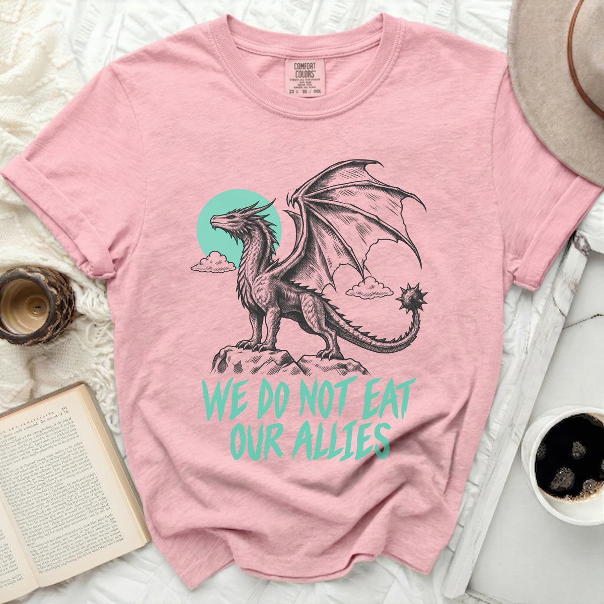 Pink t-shirt with a dragon graphic and text "WE DO NOT EAT OUR ALLIES".
