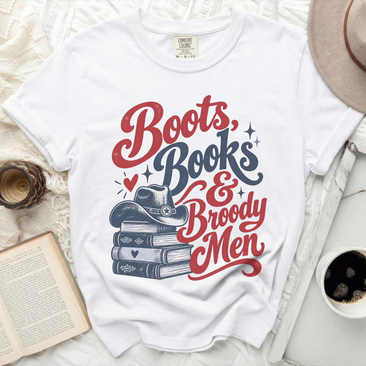 White t-shirt with "Boots, Books & Broody Men" graphic and cowboy hat.