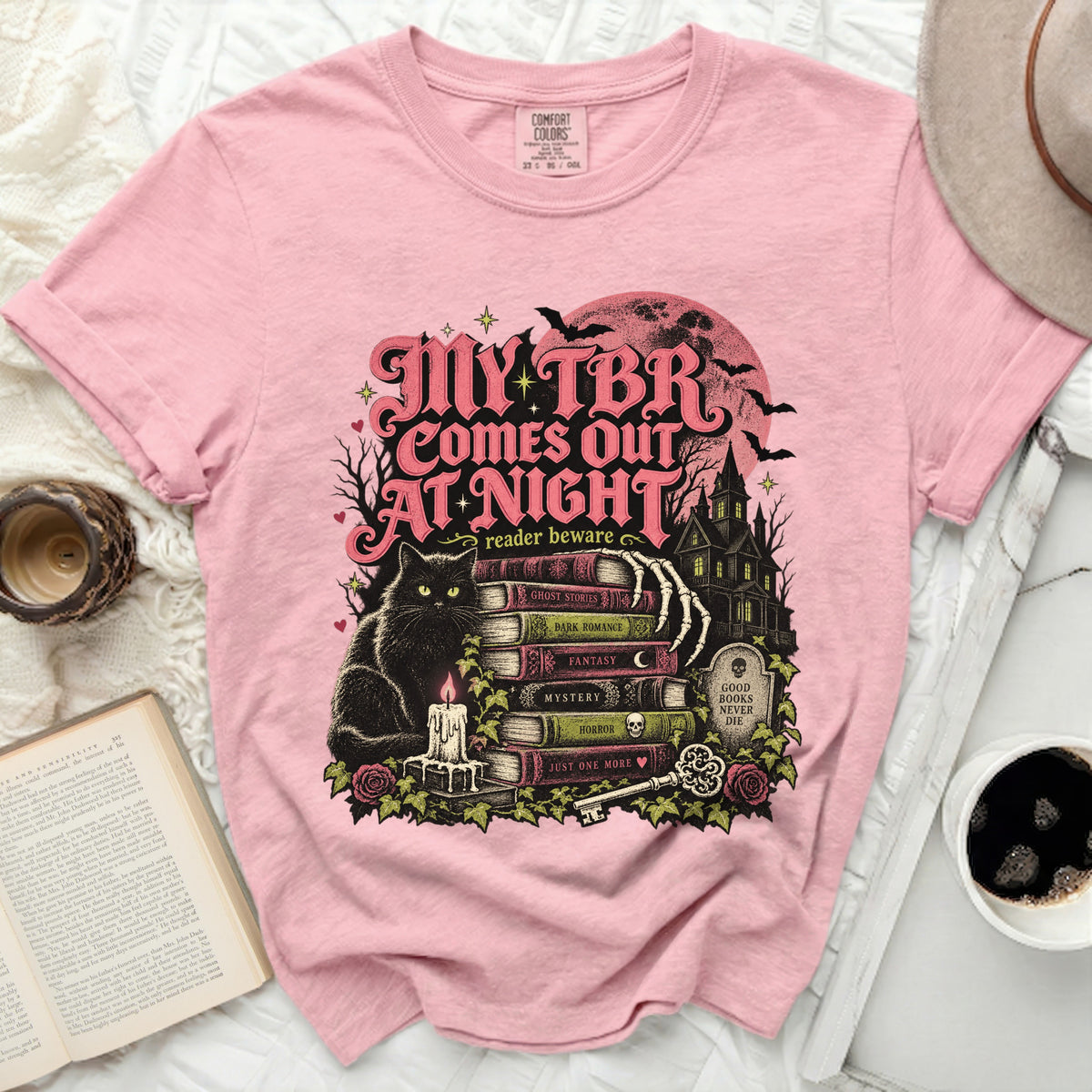 Pink t-shirt with "My TBR Comes Out At Night" Halloween-themed graphic.