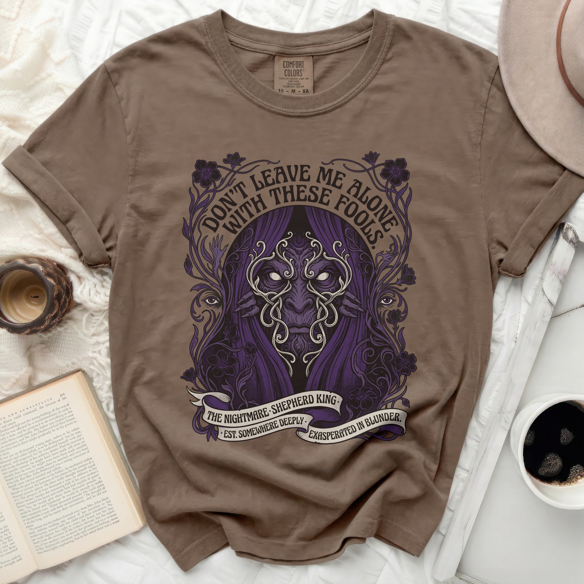 Brown t-shirt with purple graphic of a masked figure and text "Don't Leave Me Alone".