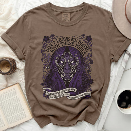 Brown t-shirt with purple graphic of a masked figure and text "Don't Leave Me Alone".