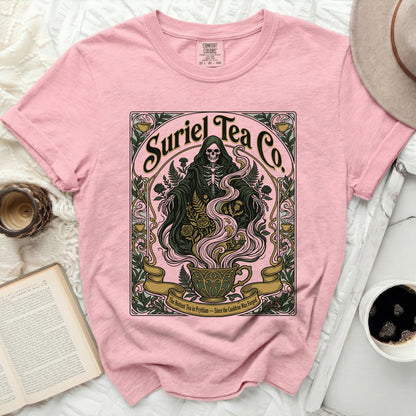 Pink t-shirt with "Suriel Tea Co." graphic of grim reaper and teacup.