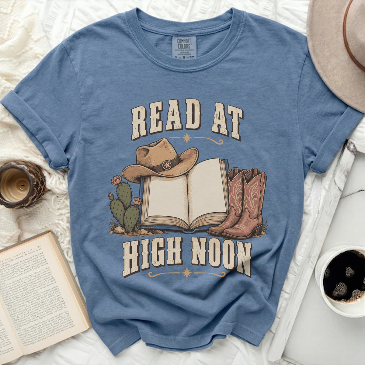T-shirt with "READ AT HIGH NOON" text, cowboy hat, boots, and cactus.