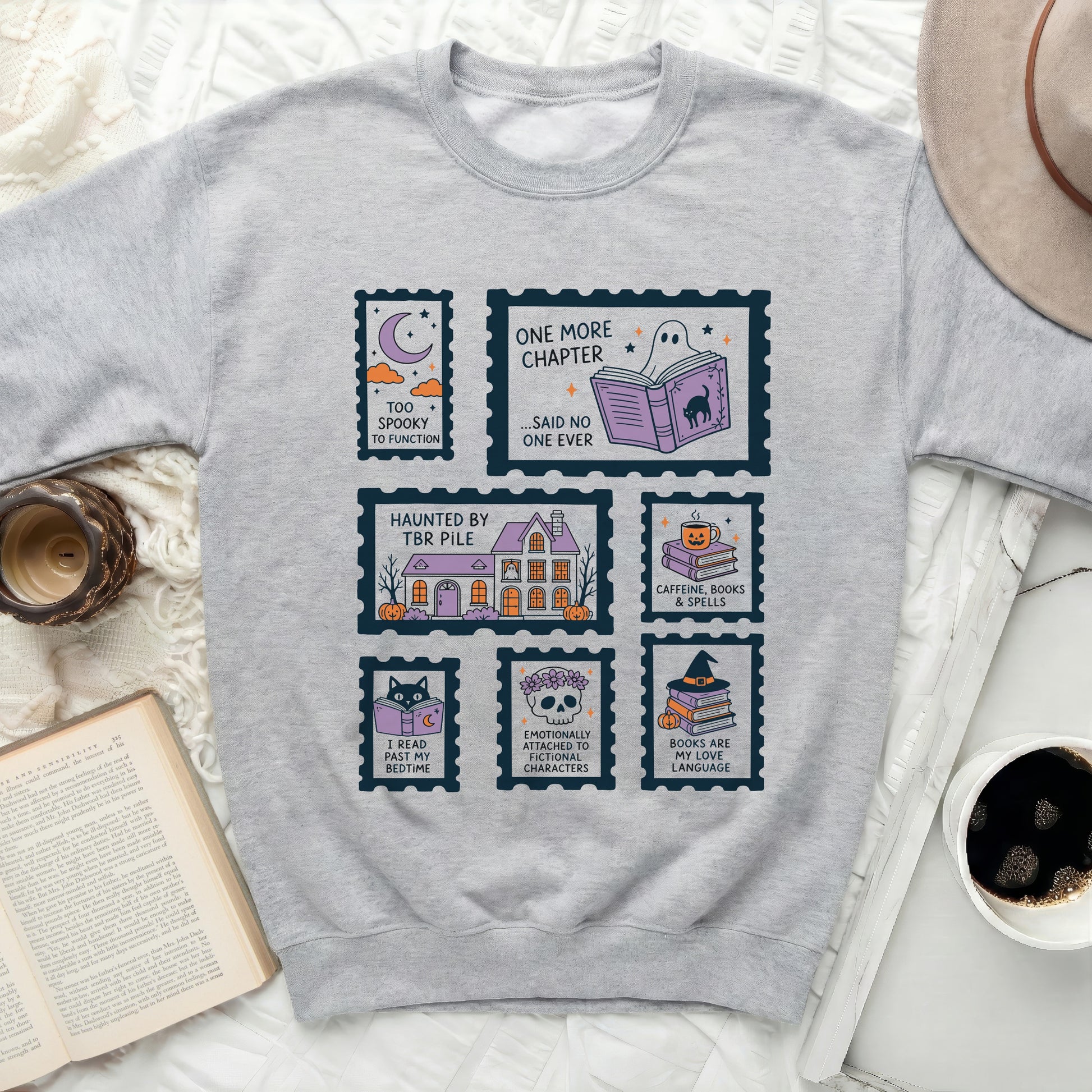 Grey sweatshirt with Halloween-themed postage stamps and book quotes.