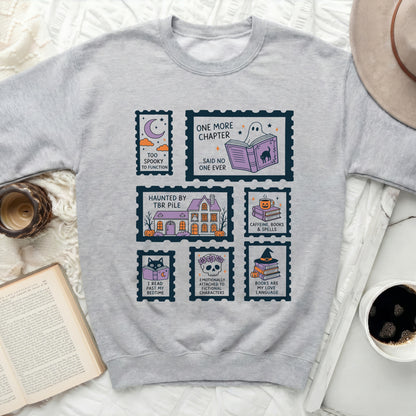 Grey sweatshirt with Halloween-themed postage stamps and book quotes.