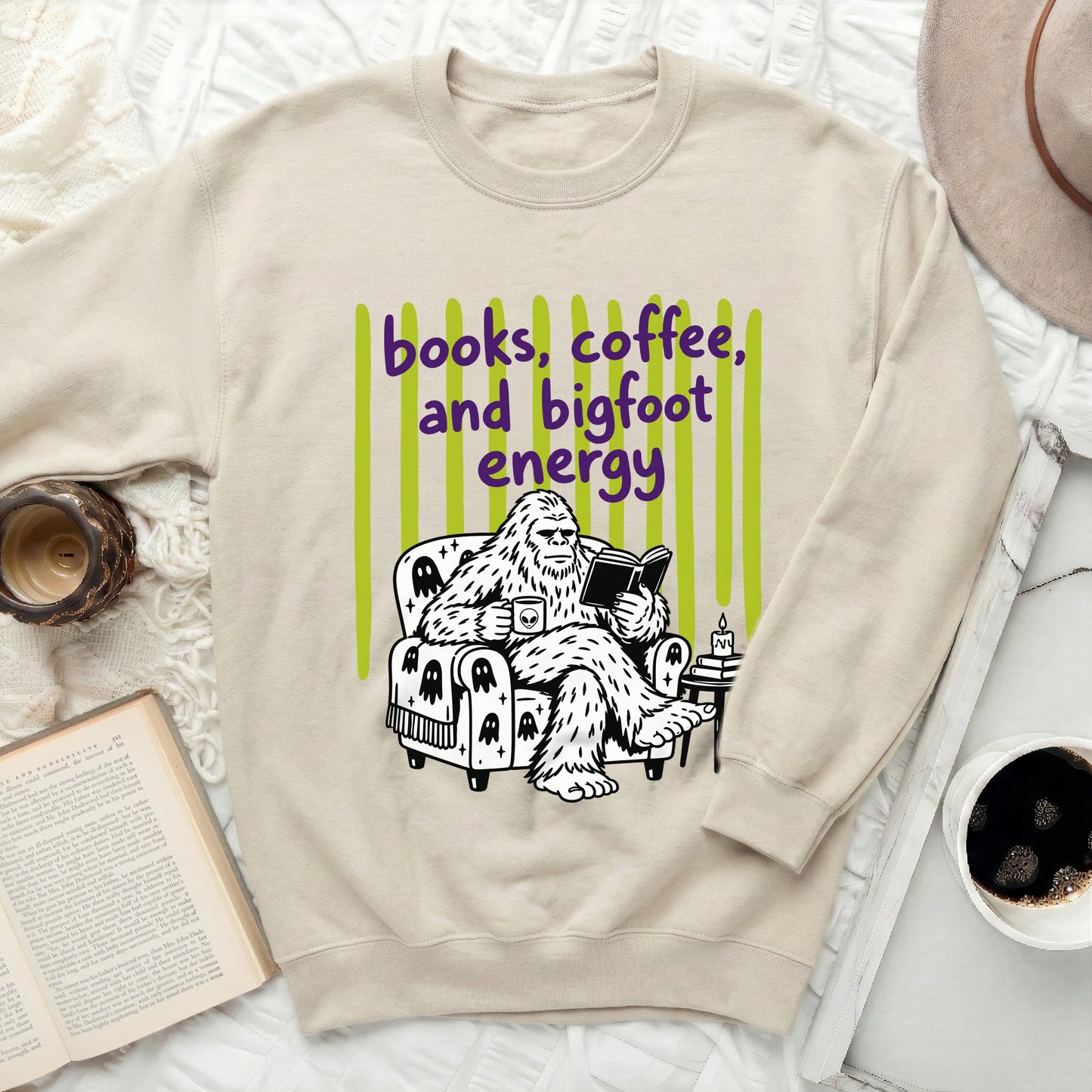 Bigfoot reading a book with "books, coffee, and bigfoot energy".