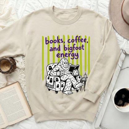Bigfoot reading a book with "books, coffee, and bigfoot energy".