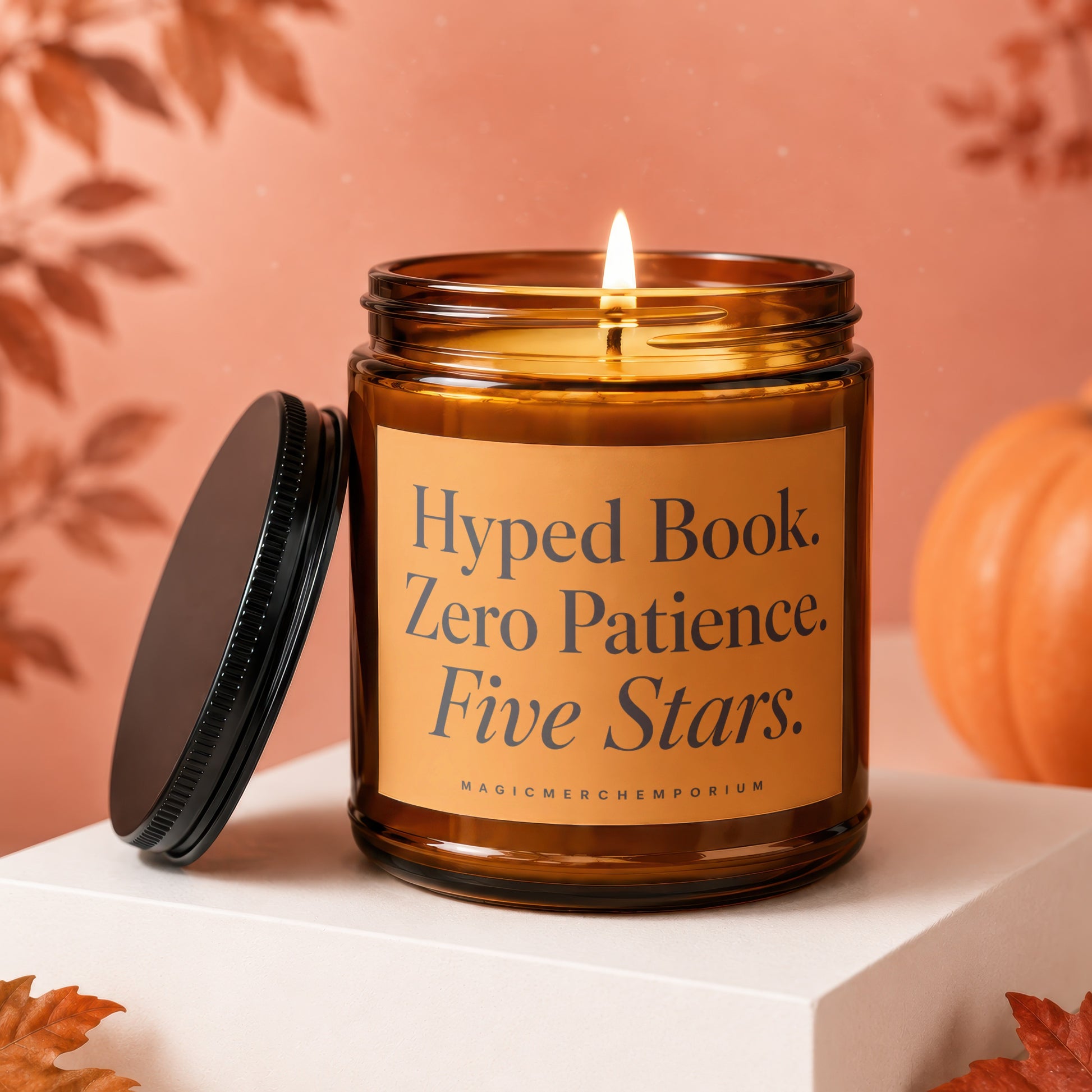 Amber jar candle with lit flame, black lid, and text "Hyped Book. Zero Patience. Five Stars.".