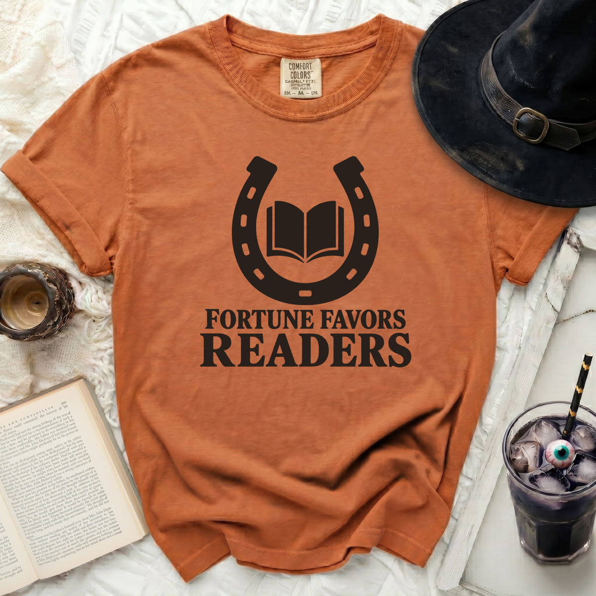 Orange t-shirt with black horseshoe, open book, and text "Fortune Favors Readers".