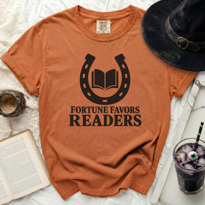 Orange t-shirt with black horseshoe, open book, and text "Fortune Favors Readers".