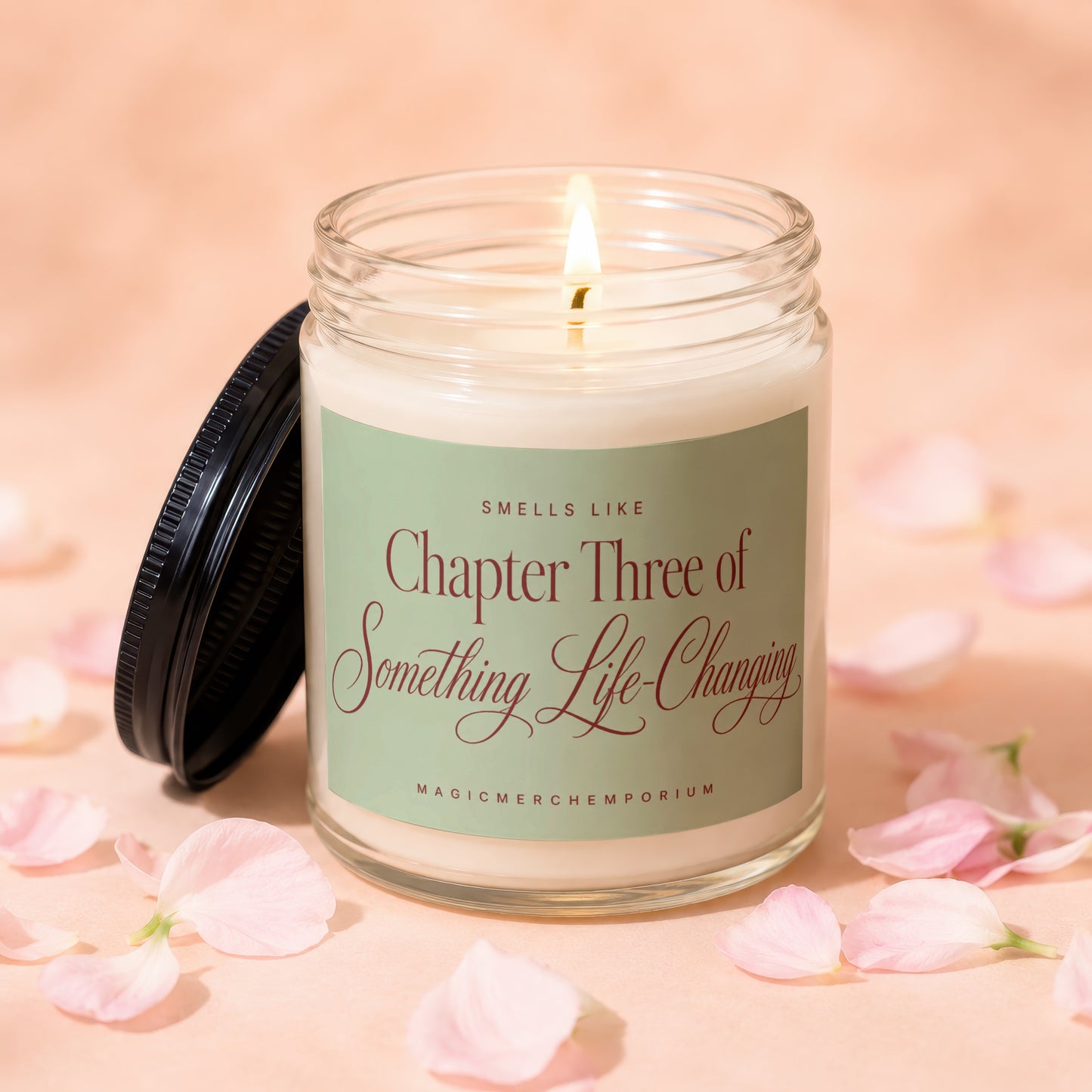Jar candle with lit wick and a label reading "Smells Like Chapter Three of Something Life-Changing".