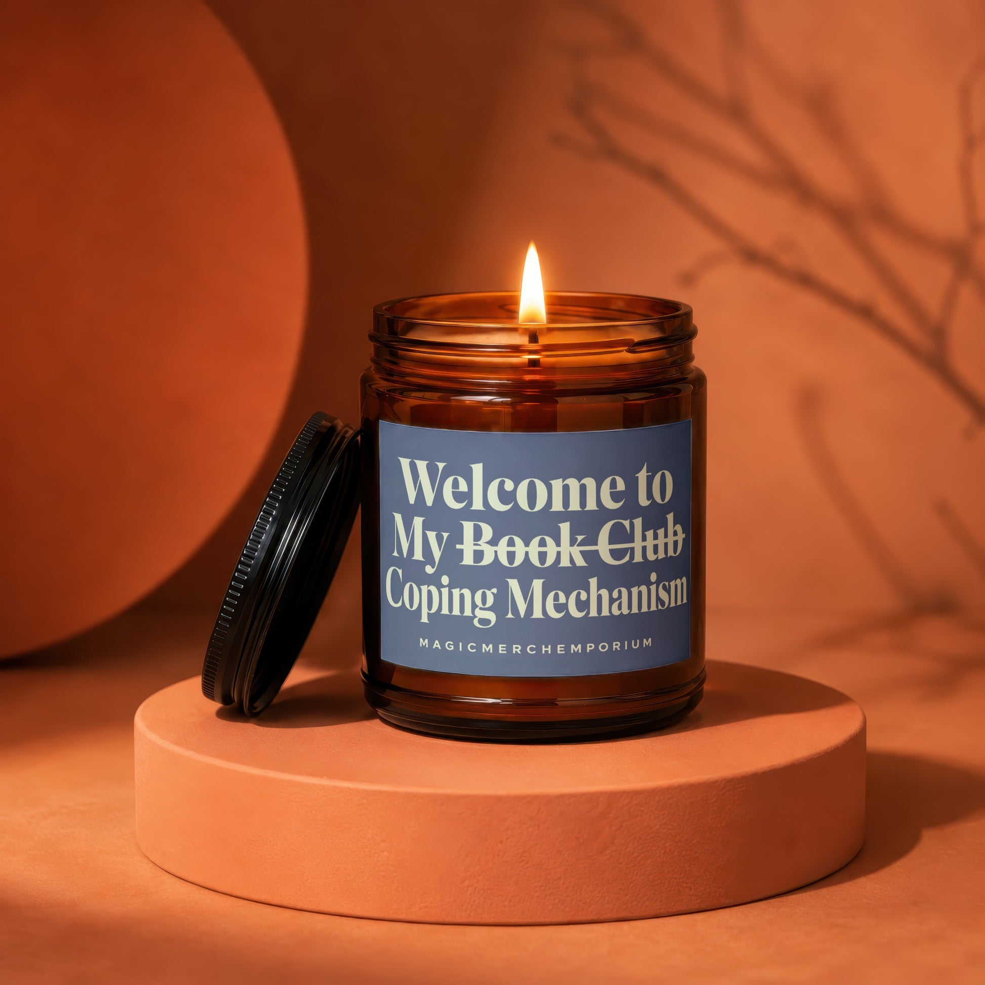 Amber jar candle with lit flame, "Welcome to My Book Club Coping Mechanism" text.