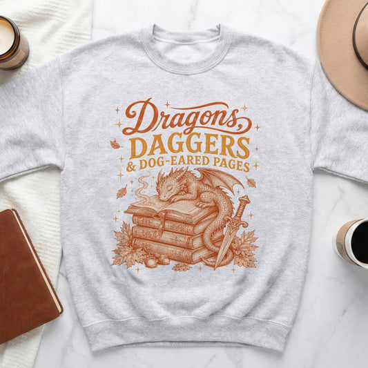 Light grey sweatshirt with the text "Dragons, Daggers & Dog-Eared Pages" and dragon image.