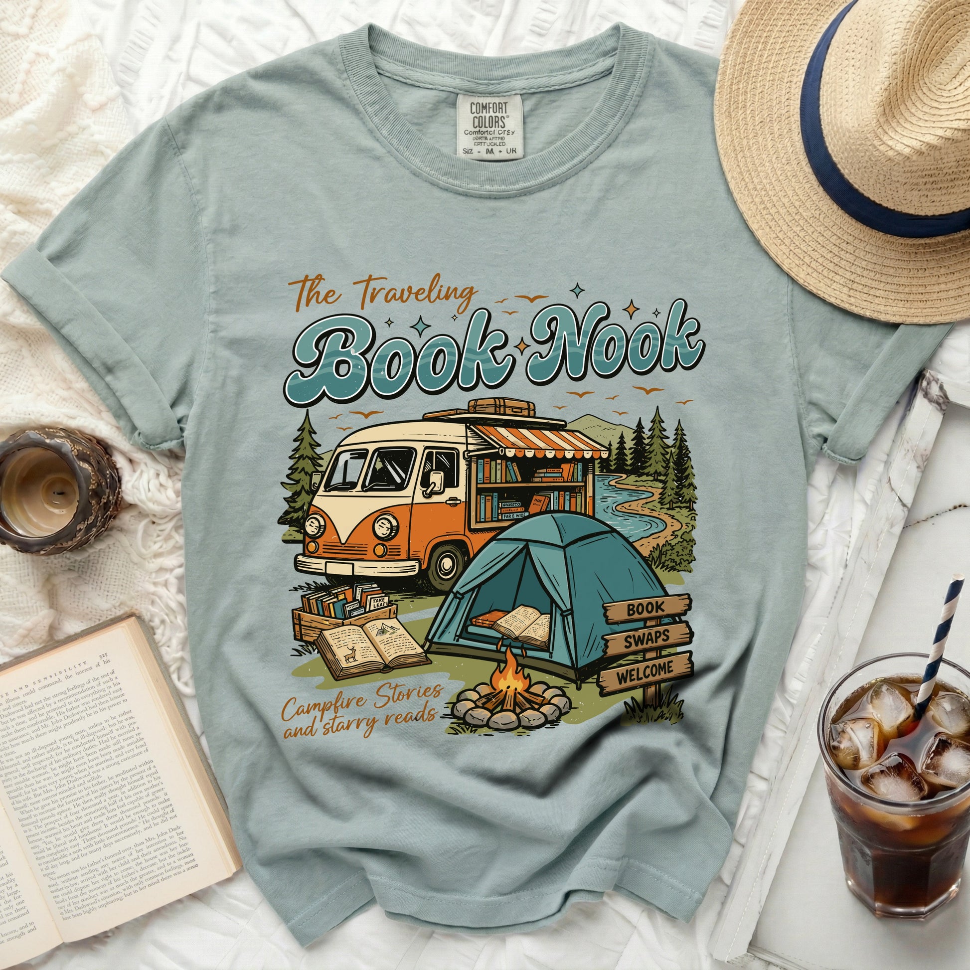 T-shirt with "The Traveling Book Nook" graphic featuring a van bookstore, tent, and campfire.