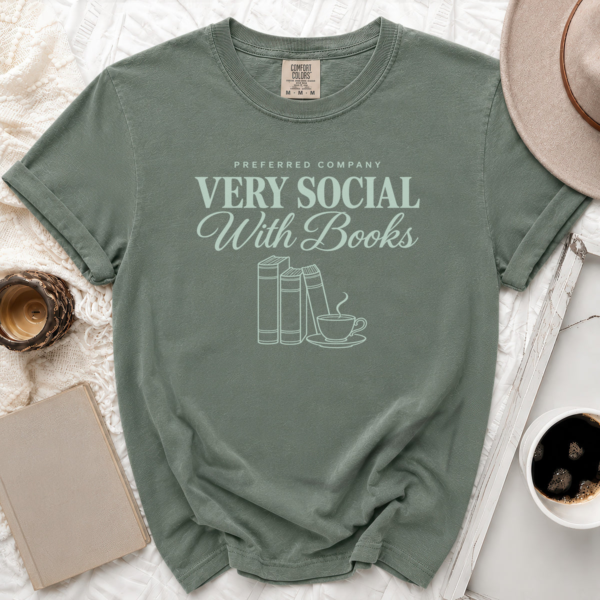 Green t-shirt with "Very Social With Books" text and book and coffee cup graphic.