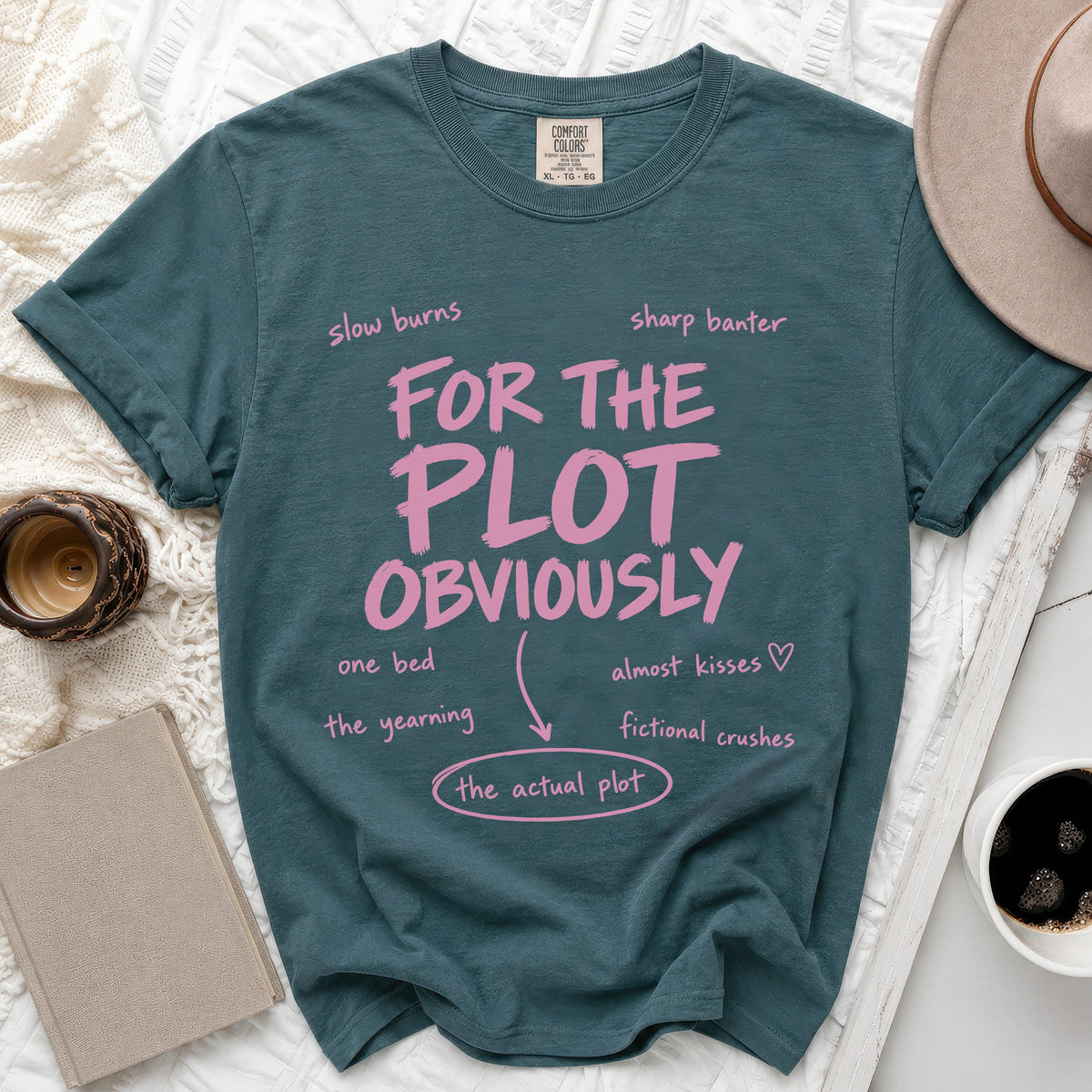 Teal t-shirt with pink text "FOR THE PLOT OBVIOUSLY" and related terms.
