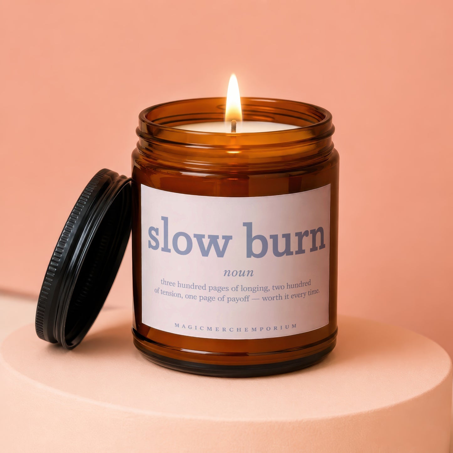 Amber jar candle with lid off, labeled "slow burn noun... worth it every time."