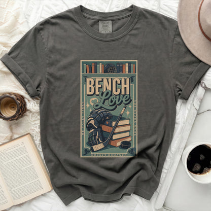 Dark t-shirt with "Bench Love Hockey Romance" text and hockey gear.