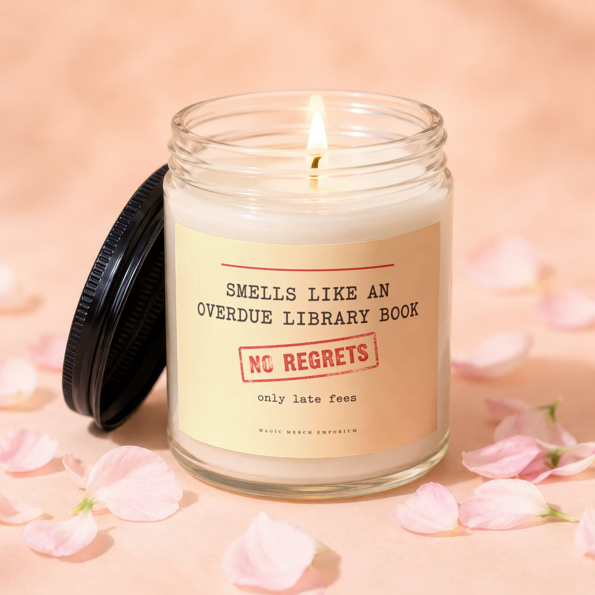 Lit candle in a jar with label: "Smells like an overdue library book. No regrets. Only late fees."