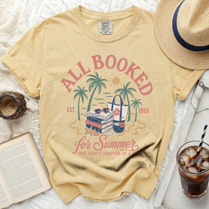 Yellow t-shirt with "All Booked for Summer" text and beach imagery.