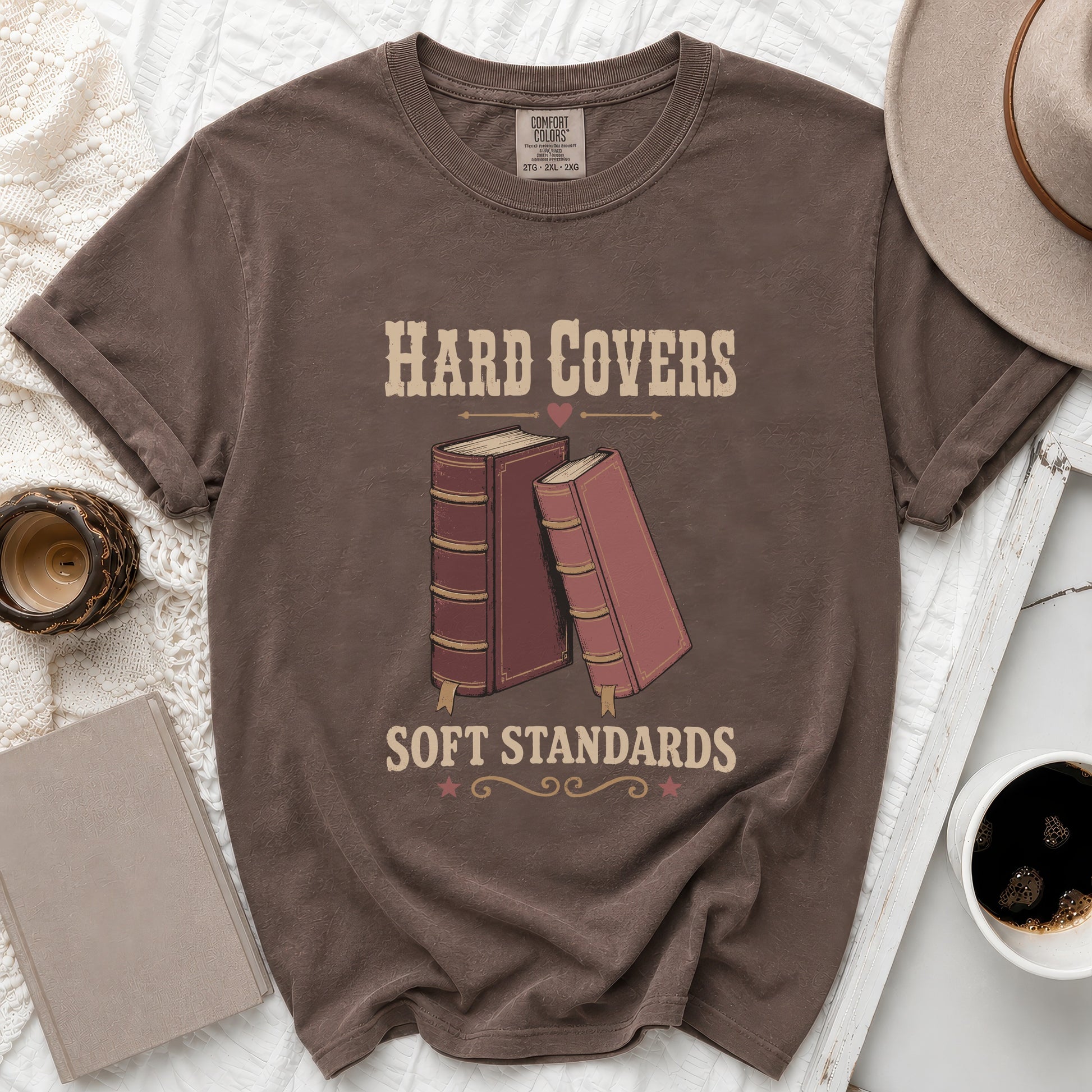 Brown t-shirt with "Hard Covers Soft Standards" text and book graphics.