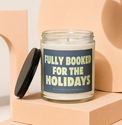 Glass candle with "Fully Booked for the Holidays" text on label.