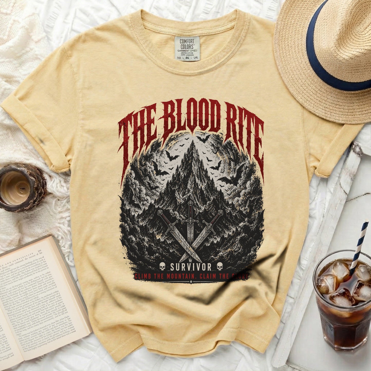 Yellow t-shirt with "The Blood Rite Survivor" graphic and mountain scene.