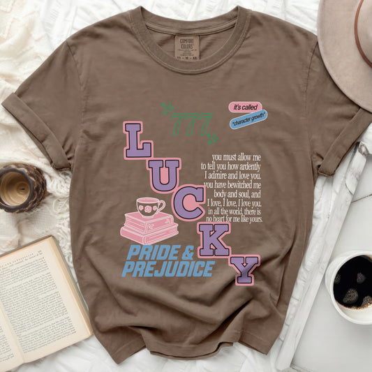 Brown t-shirt featuring "Lucky" with books, teacup, and Pride and Prejudice quote.