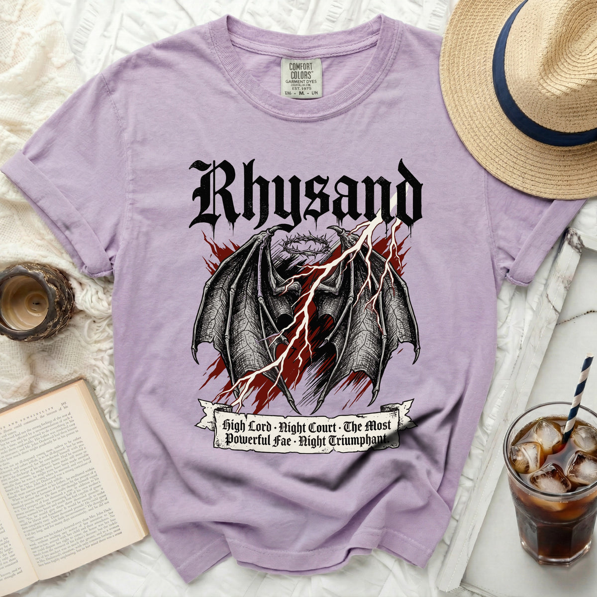 Purple t-shirt with black gothic text and dragon wings graphic.