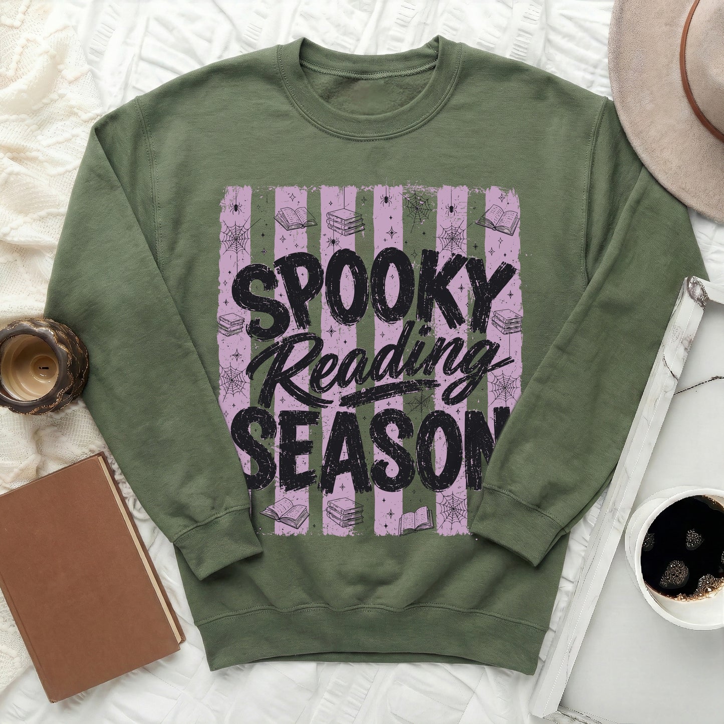 Green sweatshirt with "Spooky Reading Season" text, books, spiders, and cobwebs.