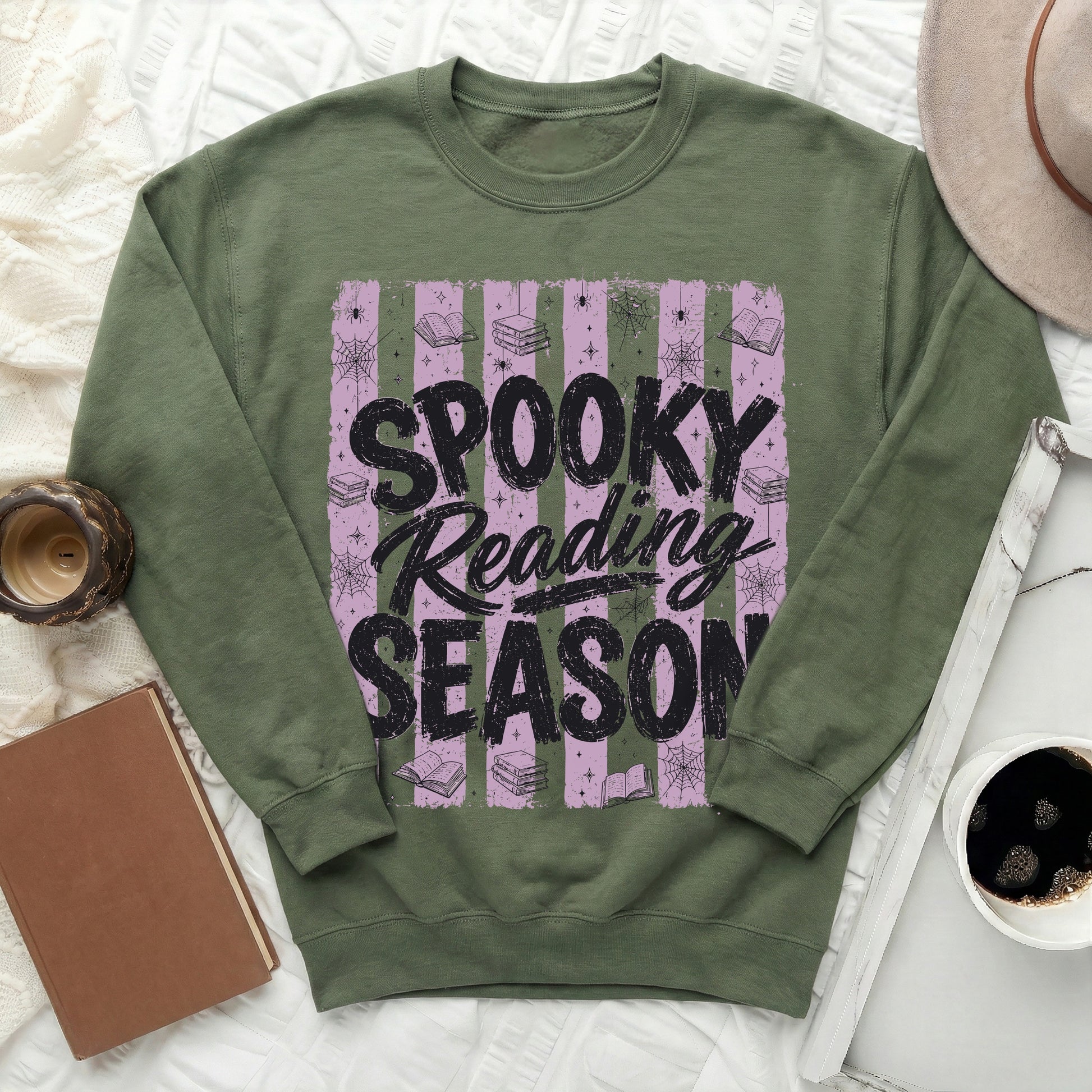 Green sweatshirt with "Spooky Reading Season" text, books, spiders, and cobwebs.