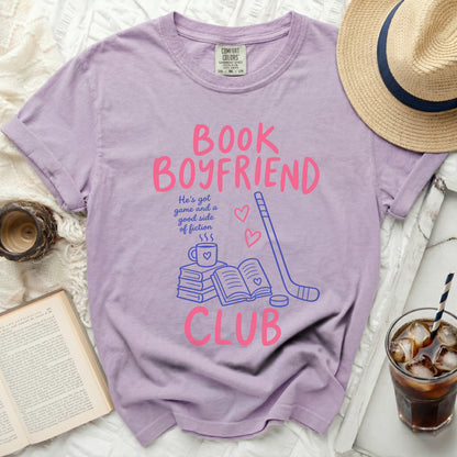 Purple t-shirt with "Book Boyfriend Club" graphic and hockey stick.