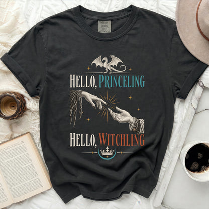 Dark t-shirt with dragon, hands reaching, and "Hello, Princeling, Hello, Witchling" text.