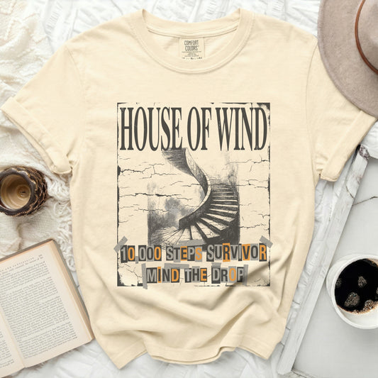 Cream t-shirt with "House of Wind 10,000 Steps Survivor Mind the Drop" graphic.