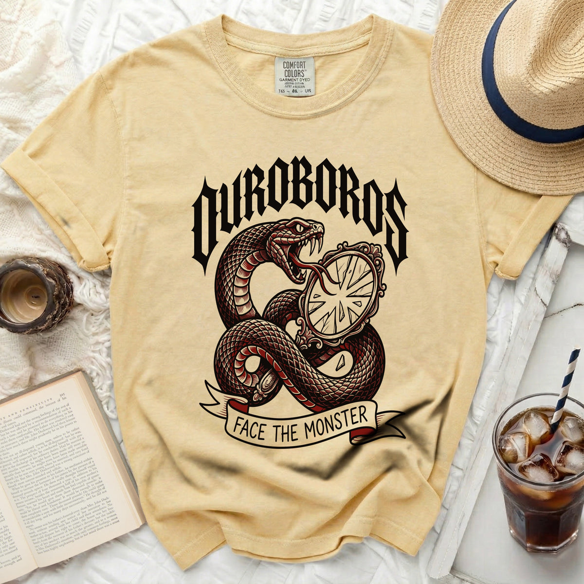 Yellow t-shirt with snake, mirror, and "OUROBOROS FACE THE MONSTER" graphic.