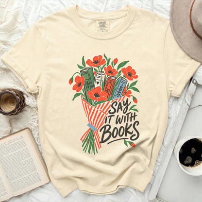 Cream t-shirt with "Say It With Books" design and floral book illustration.