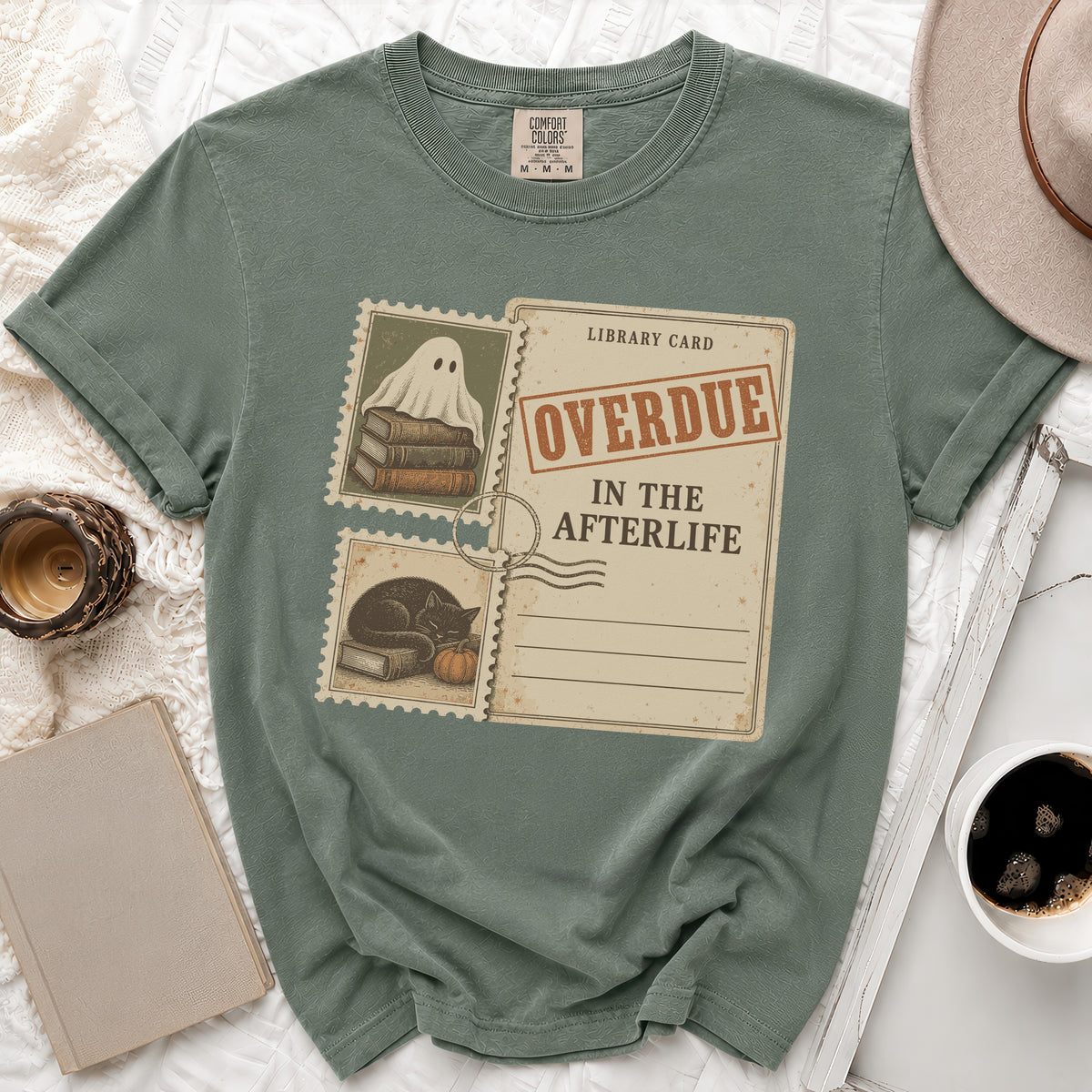 Green t-shirt with a "Library Card Overdue In The Afterlife" graphic featuring a ghost and a cat.