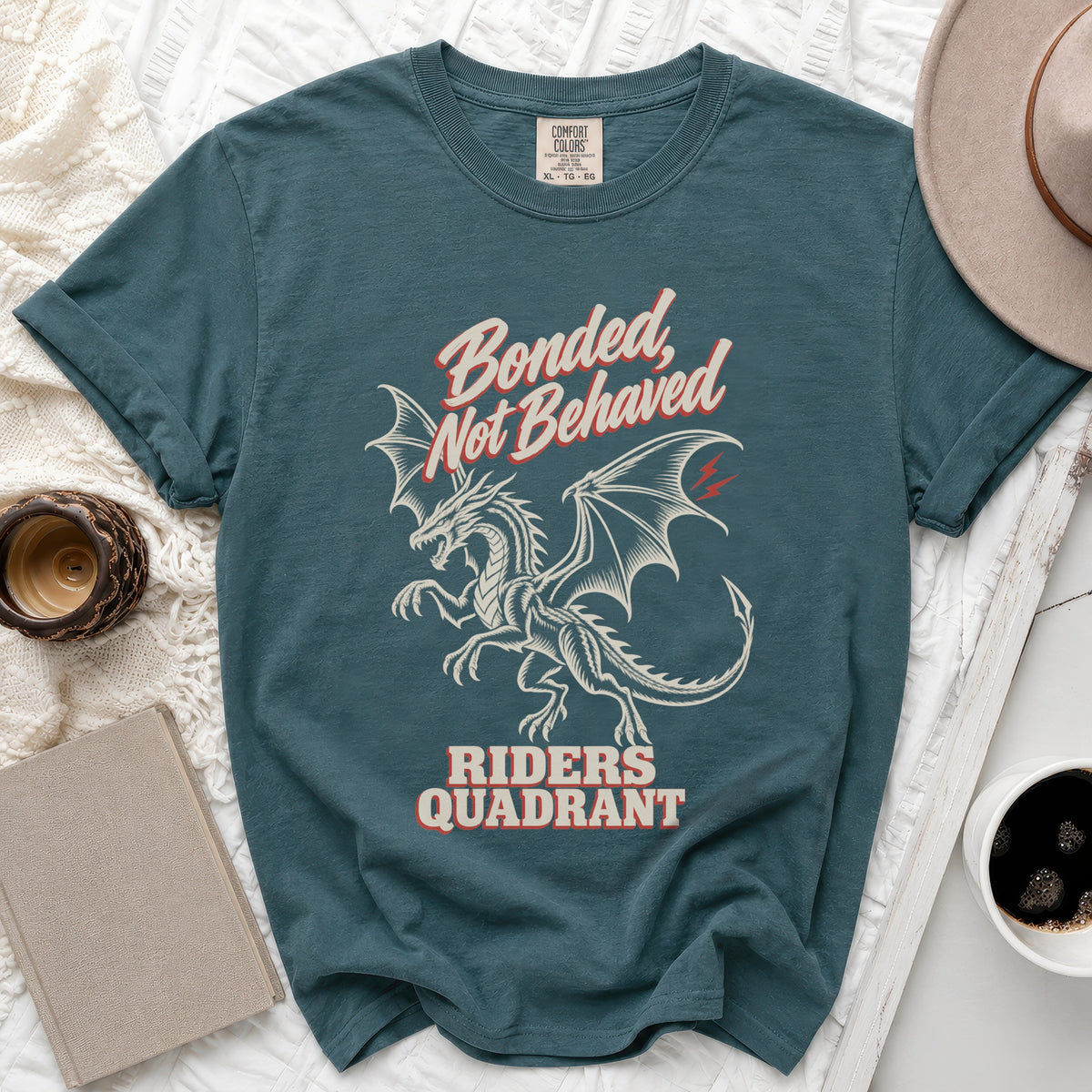Teal t-shirt with dragon graphic and text "Bonded, Not Behaved Riders Quadrant".