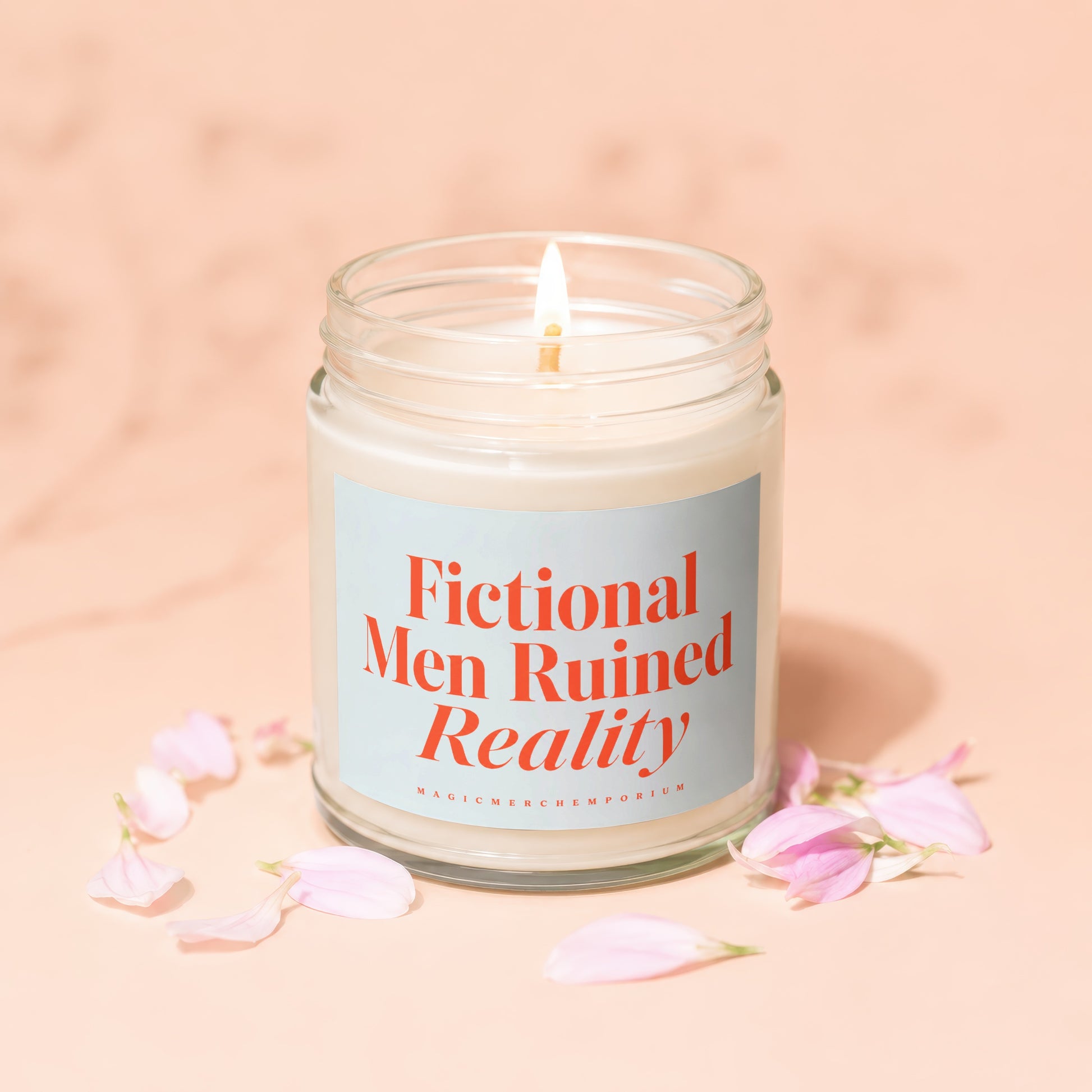 Lit candle in a glass jar with "Fictional Men Ruined Reality" text on a pale blue label.