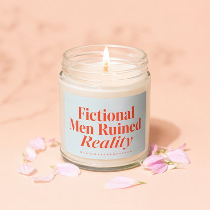 Lit candle in a glass jar with "Fictional Men Ruined Reality" text on a pale blue label.