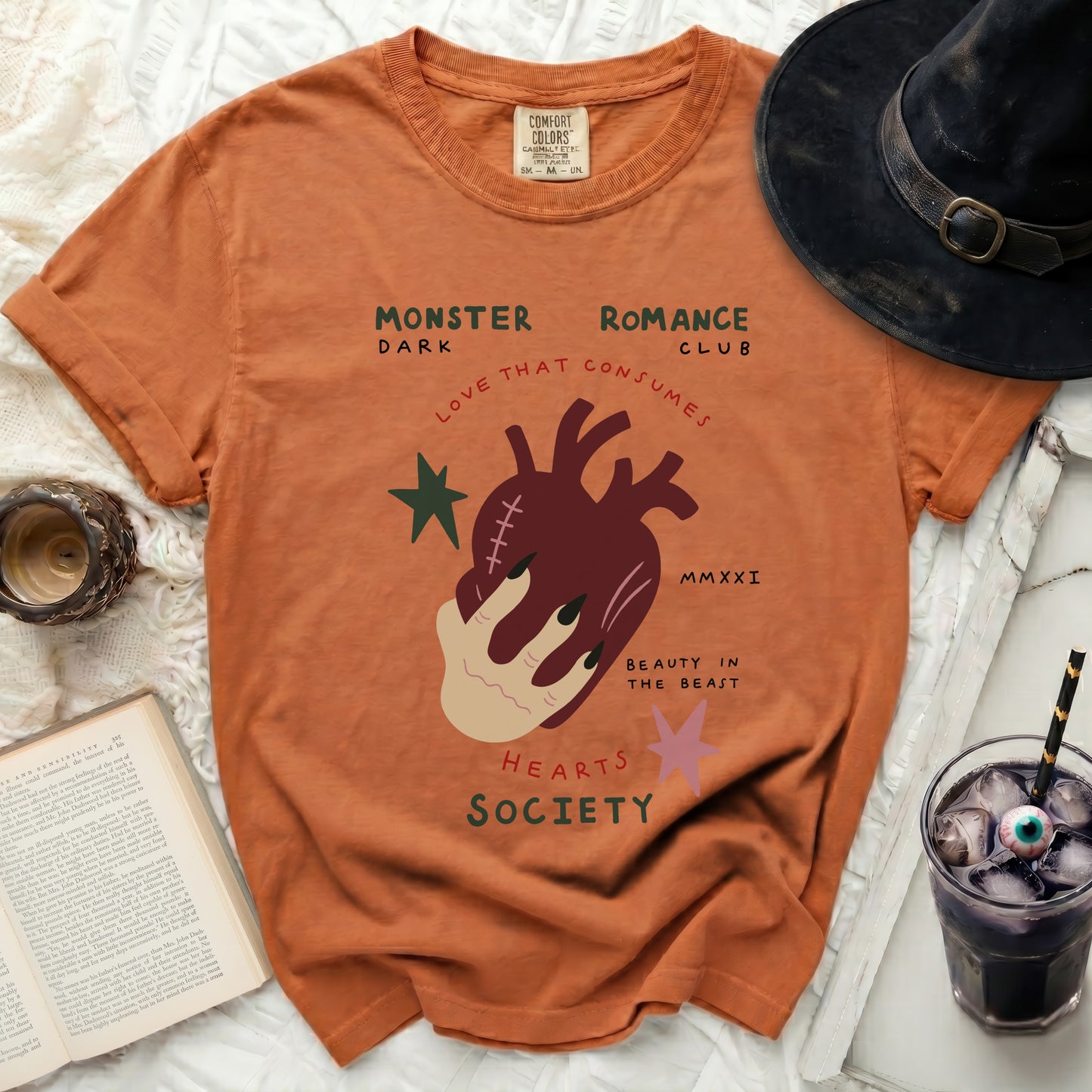 Orange t-shirt with "Monster Romance Club" text and anatomical heart graphic.