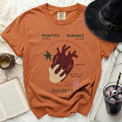 Orange t-shirt with "Monster Romance Club" text and anatomical heart graphic.