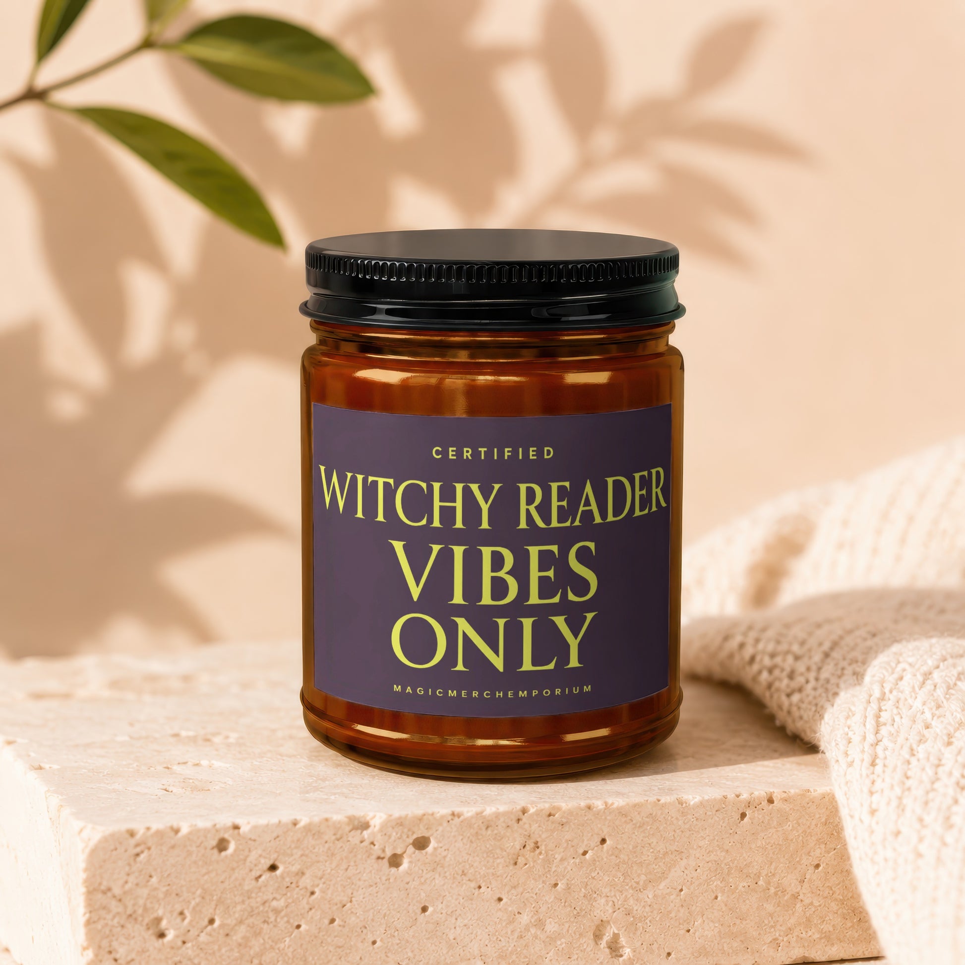 Amber jar candle with purple label saying "Certified Witchy Reader Vibes Only".