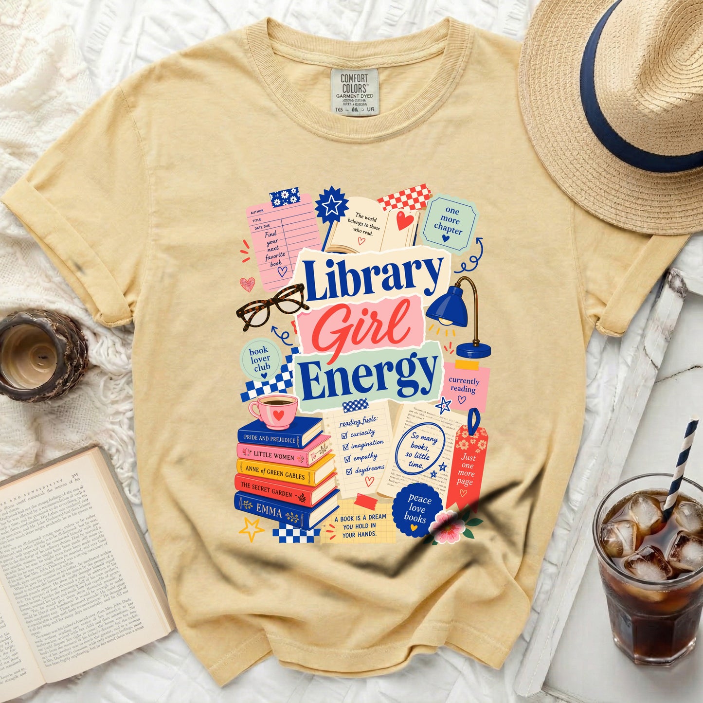 Yellow t-shirt with "Library Girl Energy" graphic and book-themed illustrations.